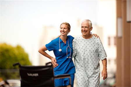 Young doctor and her elderly patient laugh together as she assists him with walking outside. Stock Photo - Premium Royalty-Free, Code: 6128-08748168
