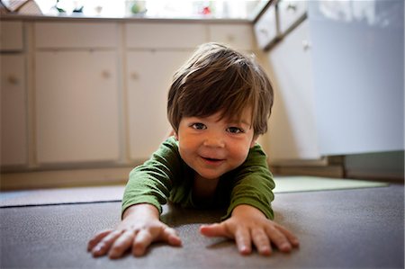 person on all four - Happy toddler crawling on kitchen floor. Stock Photo - Premium Royalty-Free, Code: 6128-08748198