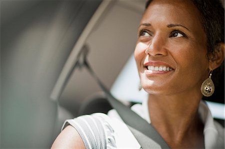 Happy mature woman looking through car window. Stock Photo - Premium Royalty-Free, Code: 6128-08748103