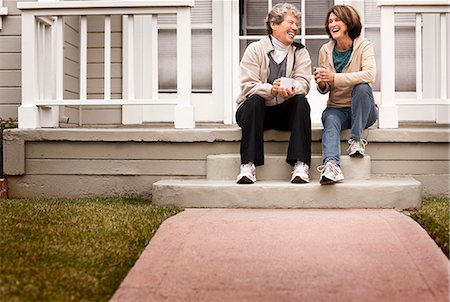 friends porch - A mother and daughter catching up over coffee on the front stoop. Stock Photo - Premium Royalty-Free, Code: 6128-08766699