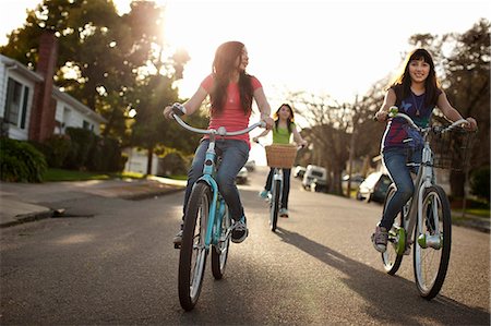 simsearch:6128-08738600,k - Three friends cycling down the road together. Stock Photo - Premium Royalty-Free, Code: 6128-08766794