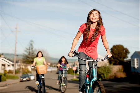 simsearch:6128-08738600,k - Group of teenage girls cycling along the street together. Stock Photo - Premium Royalty-Free, Code: 6128-08766805