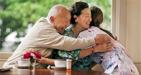 simsearch:6128-08727962,k - Excited senior couple hugging a female nurse. Stock Photo - Premium Royalty-Free, Code: 6128-08767047