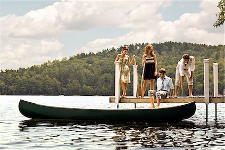 Friends hopping into a canoe in the lake. Stock Photo - Premium Royalty-Free, Code: 6128-08767079