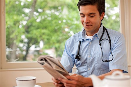 doctor reading paper - Portrait of doctor taking a break and reading the paper. Stock Photo - Premium Royalty-Free, Code: 6128-08767008