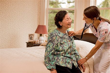 simsearch:6128-08766931,k - Nurse listening to the heartbeat of a senior woman at home. Stock Photo - Premium Royalty-Free, Code: 6128-08767014