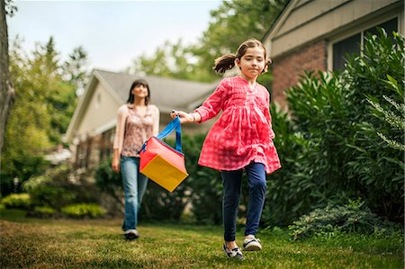 Young girl skipping while her mother watches. Stock Photo - Premium Royalty-Free, Code: 6128-08767113