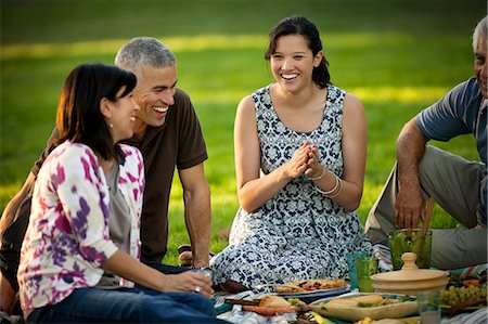 Smiling family enjoying a picnic at a park. Stock Photo - Premium Royalty-Free, Code: 6128-08767228