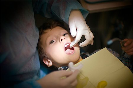 dentist child - High angle view of a young boy being examined by a dentist. Stock Photo - Premium Royalty-Free, Code: 6128-08780380