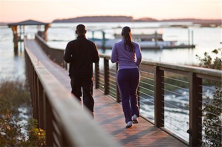 Young couple walking on pier Stock Photo - Premium Royalty-Free, Code: 6128-08780488