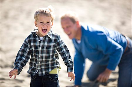 simsearch:6128-08727525,k - Father and his young son playing on a sandy beach. Stock Photo - Premium Royalty-Free, Code: 6128-08780435