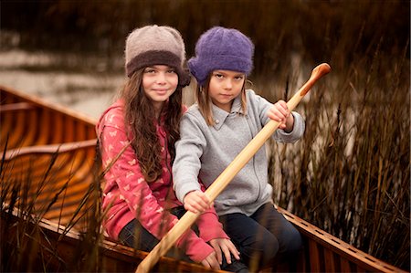 Two sisters sitting in a canoe. Stock Photo - Premium Royalty-Free, Code: 6128-08780543