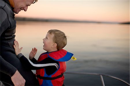 simsearch:6128-08825403,k - Father and young son laugh together on a boat. Stock Photo - Premium Royalty-Free, Code: 6128-08780567