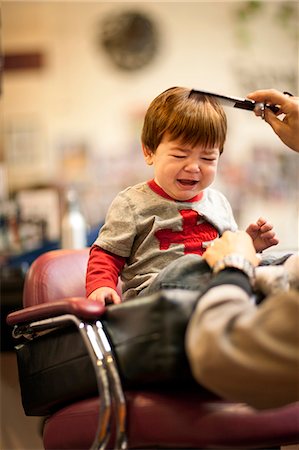 Crying baby boy getting a haircut. Stock Photo - Premium Royalty-Free, Code: 6128-08780576