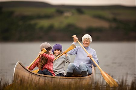 simsearch:6128-08767233,k - Senior woman paddling in a canoe with her two granddaughters. Stock Photo - Premium Royalty-Free, Code: 6128-08780538