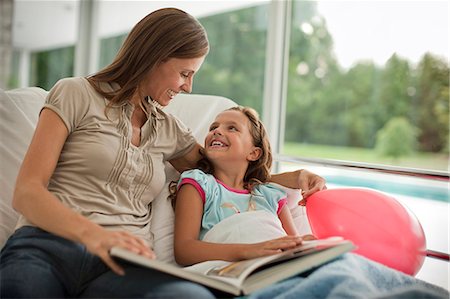 patient happy in bed - Mother reading young daughter a story in hospital. Stock Photo - Premium Royalty-Free, Code: 6128-08780678