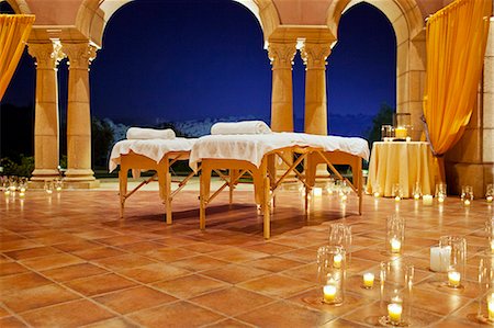 simsearch:649-08086724,k - Massage tables set up on a candlelit patio at a resort. Stockbilder - Premium RF Lizenzfrei, Bildnummer: 6128-08780601