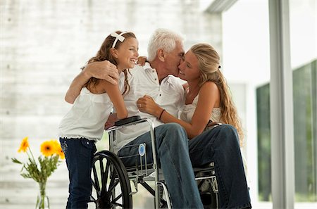 simsearch:6128-08767280,k - Senior man in wheelchair,  greeting his granddaughters. Stock Photo - Premium Royalty-Free, Code: 6128-08780727