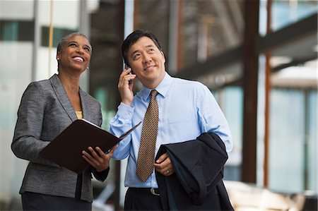 Two business colleagues discussing plans for a project on a construction site. Stock Photo - Premium Royalty-Free, Code: 6128-08780832