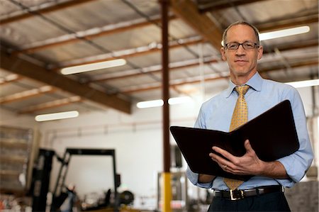 simsearch:6128-08747789,k - Portrait of a serious businessman holding a notepad. Stock Photo - Premium Royalty-Free, Code: 6128-08780837