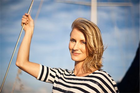 simsearch:6128-08727668,k - Portrait of mid-adult woman on a boat. Stock Photo - Premium Royalty-Free, Code: 6128-08780932