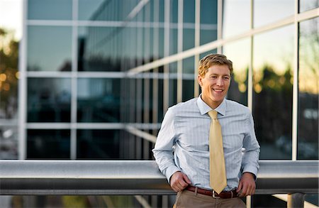 simsearch:6128-08747789,k - Young businessman standing on an office building. Stock Photo - Premium Royalty-Free, Code: 6128-08798773