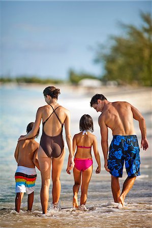 simsearch:6128-08748128,k - Happy family splashing in shallow water at a tropical beach. Stock Photo - Premium Royalty-Free, Code: 6128-08798813