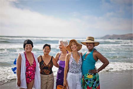 senior friends travel - Portrait of happy mature women enjoying a day at the beach. Stock Photo - Premium Royalty-Free, Code: 6128-08798932
