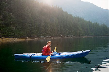 Mature man looking sheepish in a kayak Stock Photo - Premium Royalty-Free, Code: 6128-08799063