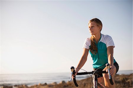 simsearch:6128-08738600,k - A young female cyclist train beside the beach. Stock Photo - Premium Royalty-Free, Code: 6128-08799138