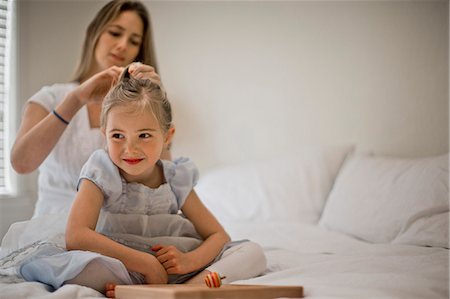 Woman styling her daughter's hair. Stock Photo - Premium Royalty-Free, Code: 6128-08727520
