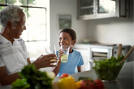 simsearch:6128-08727770,k - Grandfather and grandson enjoying lemonade together. Stock Photo - Premium Royalty-Free, Code: 6128-08727758