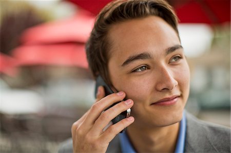 Young man talks on cell phone Stock Photo - Premium Royalty-Free, Code: 6128-08727704