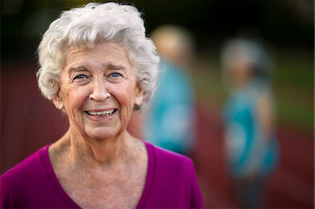 Portrait of a smiling senior woman on an athletic track. Stock Photo - Premium Royalty-Free, Code: 6128-08727865