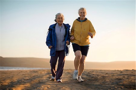 senior woman exercising by ocean - Two senior woman exercising together on the beach. Stock Photo - Premium Royalty-Free, Code: 6128-08727807