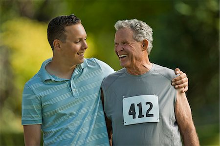 simsearch:614-07031741,k - Smiling senior boy standing with his arm around his grandfather. Photographie de stock - Premium Libres de Droits, Code: 6128-08727924