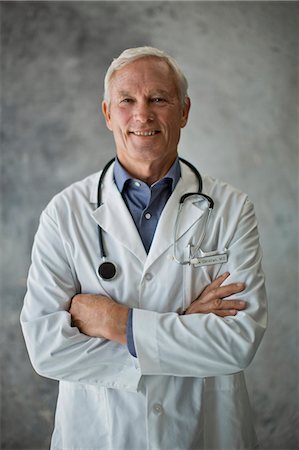 senior man happy studio - Portrait of a smiling senior doctor. Stock Photo - Premium Royalty-Free, Code: 6128-08727928