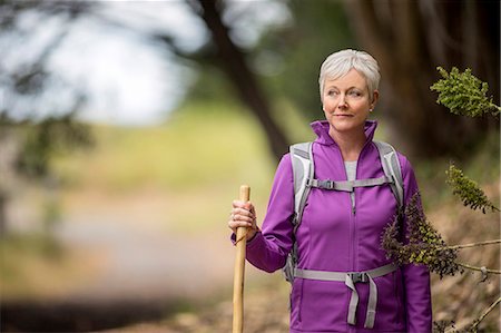 people walking a old lady - Portrait of a mature woman enjoying a peaceful hike along a forest trail. Stock Photo - Premium Royalty-Free, Code: 6128-08728014