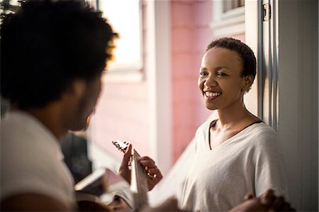 Young man playing guitar for his smiling partner. Stock Photo - Premium Royalty-Free, Code: 6128-08728159