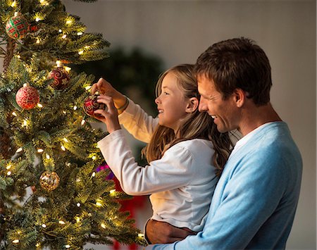 simsearch:6128-08728294,k - Happy father and daughter decorating a Christmas tree together. Stock Photo - Premium Royalty-Free, Code: 6128-08728285