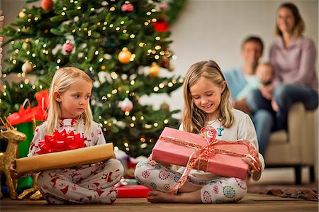 Two young girls with their Christmas presents. Stock Photo - Premium Royalty-Free, Code: 6128-08728297