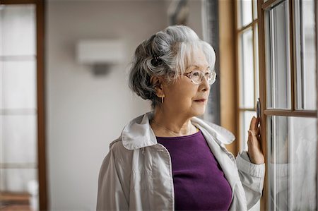 depth of field portrait - Portrait of a pensive senior woman looking out a window. Stock Photo - Premium Royalty-Free, Code: 6128-08728202