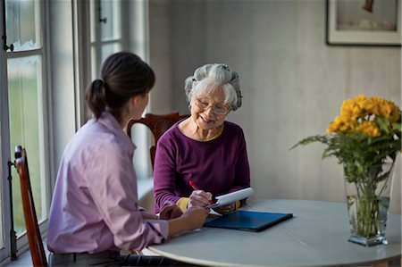 Elderly woman speaking with her doctor. Stock Photo - Premium Royalty-Free, Code: 6128-08728205