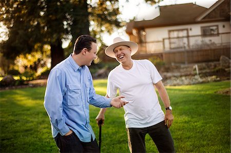 simsearch:6128-08737935,k - Happy father and son laughing together in their backyard. Stock Photo - Premium Royalty-Free, Code: 6128-08728237