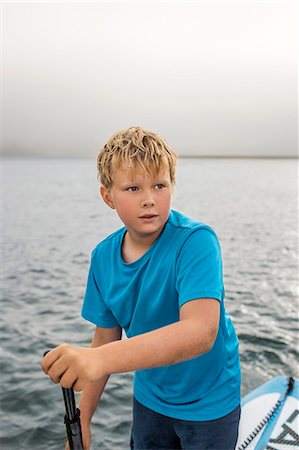 paddleboarding - Young boy paddleboarding. Stock Photo - Premium Royalty-Free, Code: 6128-08728362