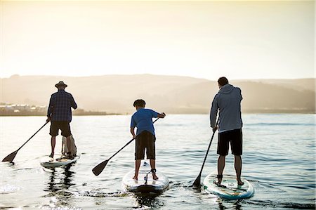 sports kids dad - Father paddleboarding with his sons. Stock Photo - Premium Royalty-Free, Code: 6128-08728365