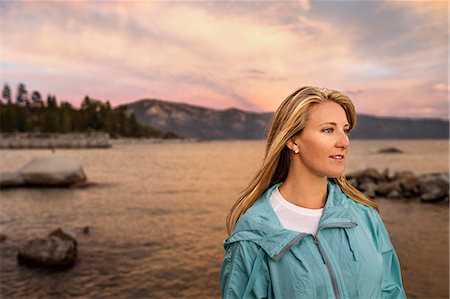 simsearch:6128-08728334,k - Young woman standing by a lake at sunset. Stock Photo - Premium Royalty-Free, Code: 6128-08728333