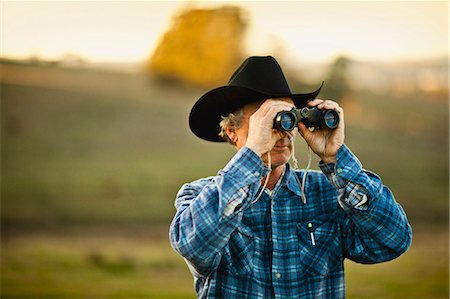 ranchers - Farmer looking through binoculars on a paddock. Stock Photo - Premium Royalty-Free, Code: 6128-08737552