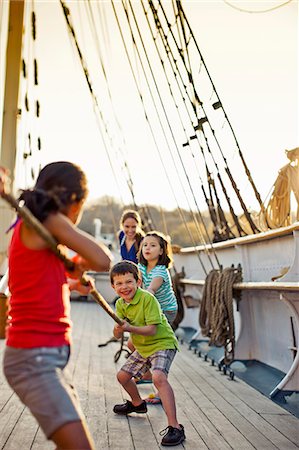 family tug of war - Family playing tug of war on ship deck. Stock Photo - Premium Royalty-Free, Code: 6128-08737766