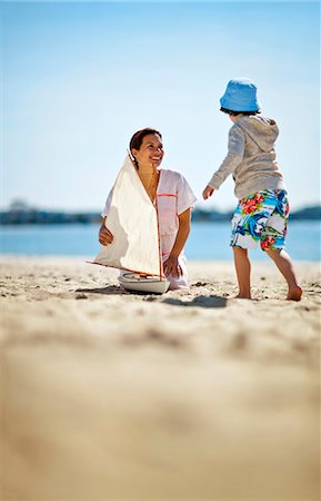 family with children in boat - Mother and young son with model yacht. Stock Photo - Premium Royalty-Free, Code: 6128-08737780